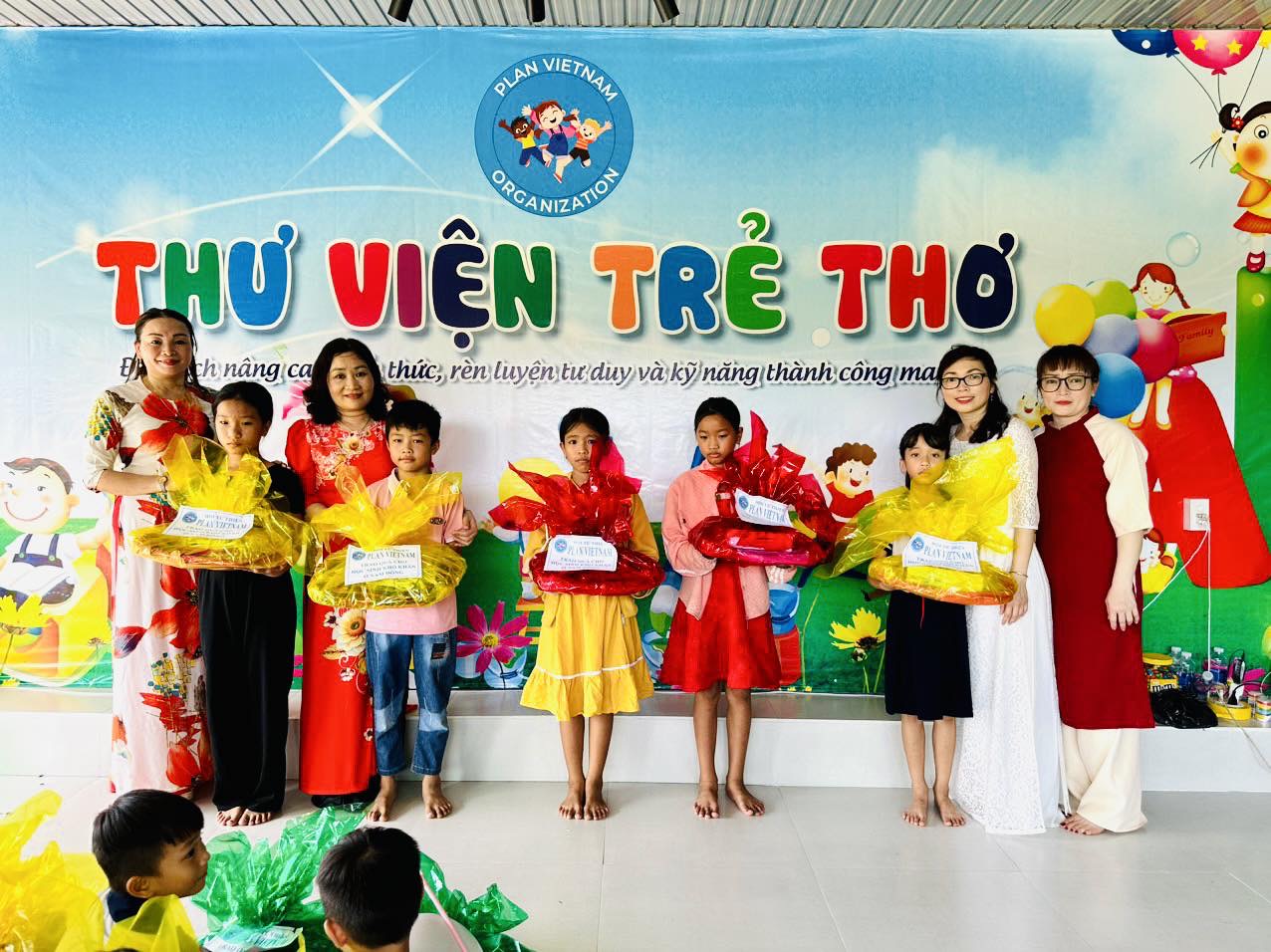 PlanVN volunteers and children at a community activity